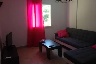 a living room with a couch and a table at Villa SERENA in Sarrola-Carcopino