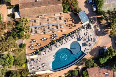 an overhead view of a building with a swimming pool at Hotel U Paesolu in Sainte-Lucie de Porto-Vecchio
