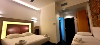 a hotel room with two beds with towels on them at Kallisté in Ajaccio
