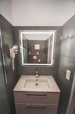 a bathroom with a sink and a mirror at Kallisté in Ajaccio