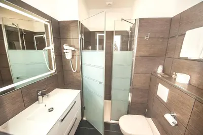 a bathroom with a sink and a toilet and a mirror at Kallisté in Ajaccio