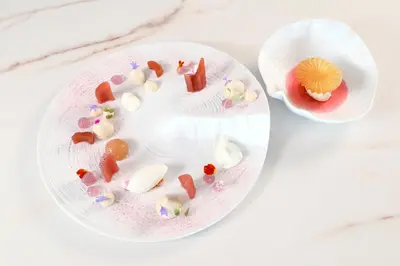 a restaurant with a table and chairs and a kitchen at Hôtel Marinca & Spa in Olmeto