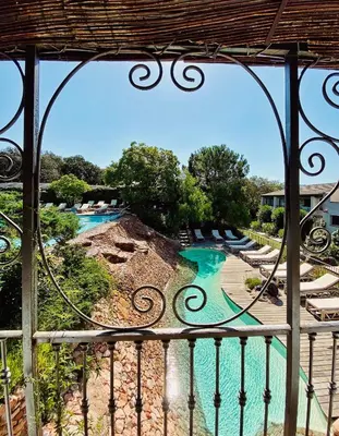 a view of a water park from a balcony at Hôtel Le Roi Théodore & Spa in Porto-Vecchio