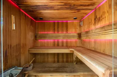 a sauna with a bench in a wooden room at Hôtel Le Roi Théodore & Spa in Porto-Vecchio