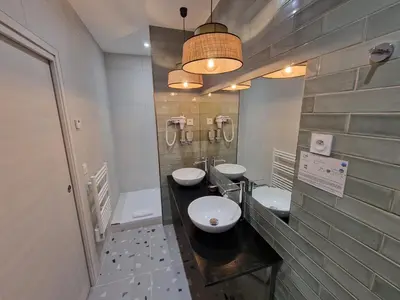 a bathroom with two sinks and two toilets at Hôtel Bella Vista in Porto Ota