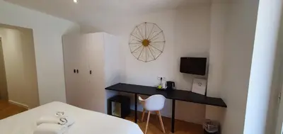 a room with a desk and a table and a chair at Hôtel Bella Vista in Porto Ota