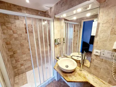 a bathroom with a sink and a shower at Hôtel Bella Vista in Porto Ota