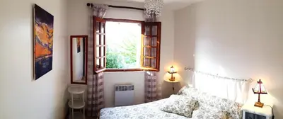 a bedroom with a bed and a window at GITE , Maison de vacances avec extérieur et terrasse fleurie meublé tourisme 3 étoiles in Poggio-di-Tallano