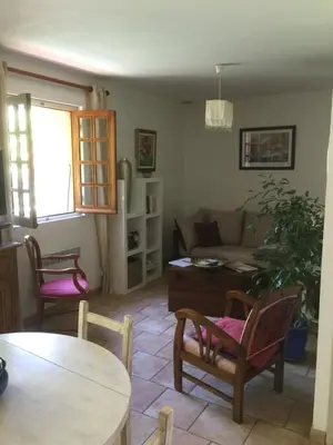 a living room with a couch and a table and chairs at GITE , Maison de vacances avec extérieur et terrasse fleurie meublé tourisme 3 étoiles in Poggio-di-Tallano