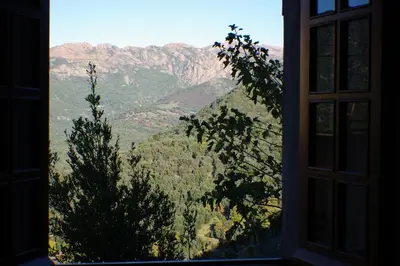a window with a view of a mountain at GITE , Maison de vacances avec extérieur et terrasse fleurie meublé tourisme 3 étoiles in Poggio-di-Tallano