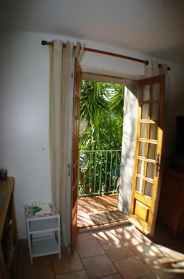 an open door to a room with a balcony at GITE , Maison de vacances avec extérieur et terrasse fleurie meublé tourisme 3 étoiles in Poggio-di-Tallano