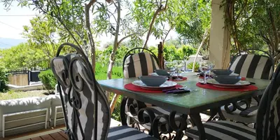 a table and chairs sitting on a patio at Les jardins de Porto Pollo in Porto Pollo
