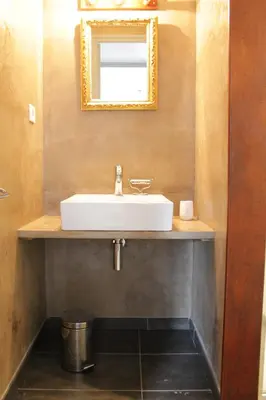 a bathroom with a white sink and a mirror at Les jardins de Porto Pollo in Porto Pollo