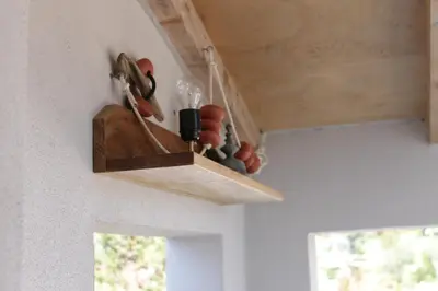 a wooden shelf with some tools on a ceiling at Les jardins de Porto Pollo in Porto Pollo