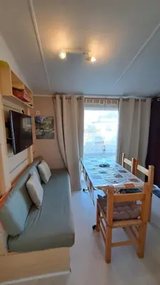 a living room with a couch and a table in a caravan at Muntagn' home in Corte