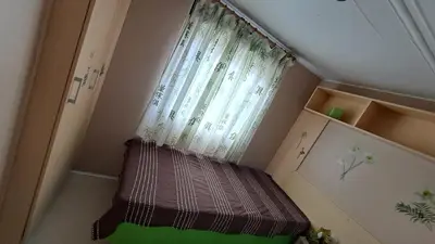a small room with a window with a curtain at Muntagn' home in Corte