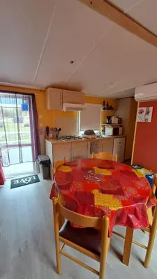 a kitchen with a table with a red table cloth on it at Muntagn' home in Corte
