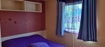 a bedroom with a purple bed and a window at Muntagn' home in Corte