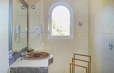 a bathroom with a sink and a window at Cozy Home In Moriani Plage With Wifi in Moriani Plage
