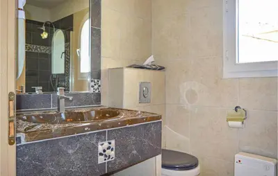 a bathroom with a sink and a toilet at Cozy Home In Moriani Plage With Wifi in Moriani Plage