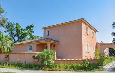 a large brick house with a fence in front of it at Cozy Home In Moriani Plage With Wifi in Moriani Plage