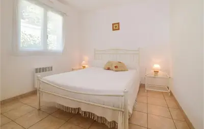 a white bed in a white room with a window at 3 Bedroom Nice Home In Moriani Plage in Moriani Plage