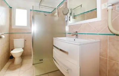 a bathroom with a sink and a toilet at 3 Bedroom Nice Home In Moriani Plage in Moriani Plage