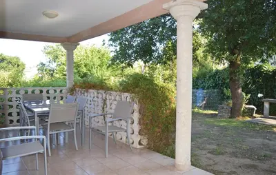 a table and chairs on a patio under a pergola at 3 Bedroom Nice Home In Moriani Plage in Moriani Plage
