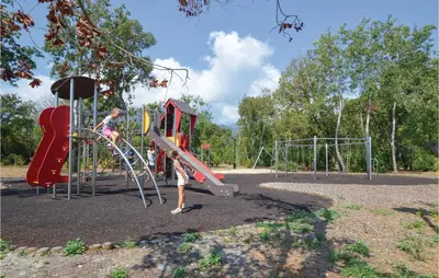 a group of children playing on a playground at Nice Apartment In Moriani Plage in Moriani Plage