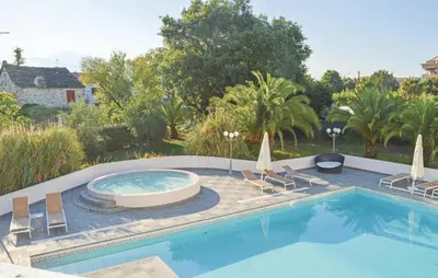a swimming pool with lounge chairs and a swimming pool at Nice Apartment In Moriani Plage in Moriani Plage