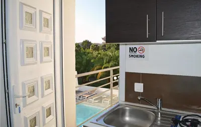 a kitchen with a sink and a no swearing sign on a door at Nice Apartment In Moriani Plage in Moriani Plage