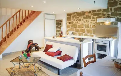 a living room with a white couch and a table at Nice Apartment In Sollacaro With Wifi in Sollacaro