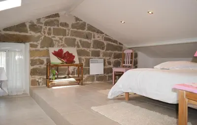 a bedroom with a stone wall and a bed at Nice Apartment In Sollacaro With Wifi in Sollacaro