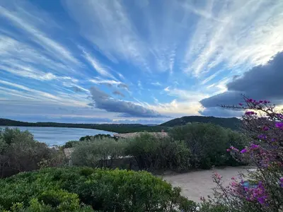 a view of a body of water under a cloudy sky at Villa Libecciu in Sainte-Lucie de Porto-Vecchio