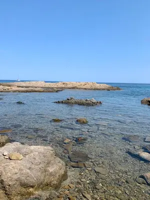 a body of water with rocks in the water at Appartement I Cardellini in Sari Solenzara