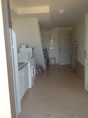 a laundry room with a washer and dryer in it at A Stalla in Piana
