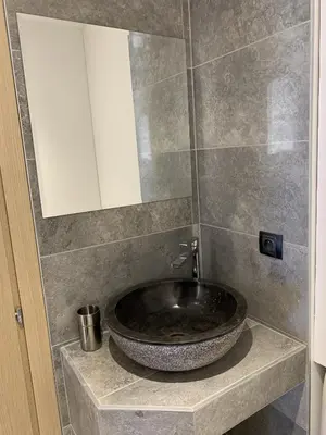 a bathroom with a bowl sink on a counter at Résidence Les Jardins du Fort in Porticcio