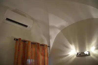 a room with a wall with a light and a curtain at maison corse en balagne in Cateri
