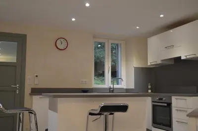 a kitchen with a sink and a clock on the wall at maison corse en balagne in Cateri