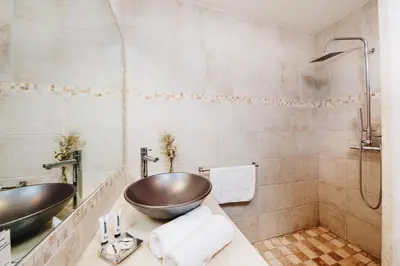 a bathroom with two sinks and a shower at B&B A Chjusellina in Corte