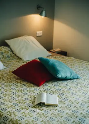 a book sitting on top of a bed with pillows at B&B A Chjusellina in Corte