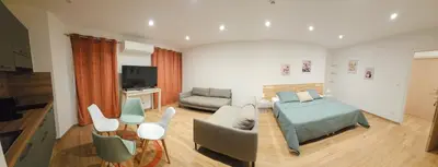 a bedroom with a bed and a living room with a couch at Accendi Pipa in Campitello