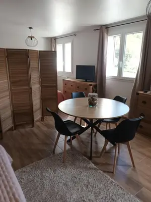 a living room with a table and chairs at Accendi Pipa in Campitello