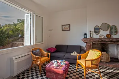 a living room with a couch and chairs and a fireplace at Villa Kalliste in Porto Ota