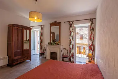 a living room with a bed and a fireplace at Gîte Du Pont - Piana in Piana