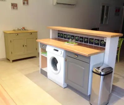 a kitchen with a washing machine and a counter at Apartement Alba Oletta in Oletta