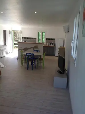 a kitchen and dining room with a table and chairs at Apartement Alba Oletta in Oletta