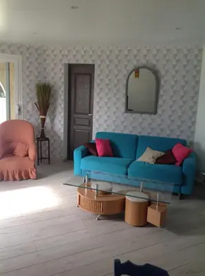 a living room with a blue couch and a mirror at Apartement Alba Oletta in Oletta