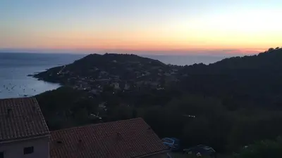 a view of a town on a hill at sunset at Panoramic Seaview studio Tiuccia in Casaglione