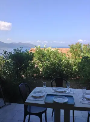 a table with two chairs and a view of the ocean at Panoramic Seaview studio Tiuccia in Casaglione
